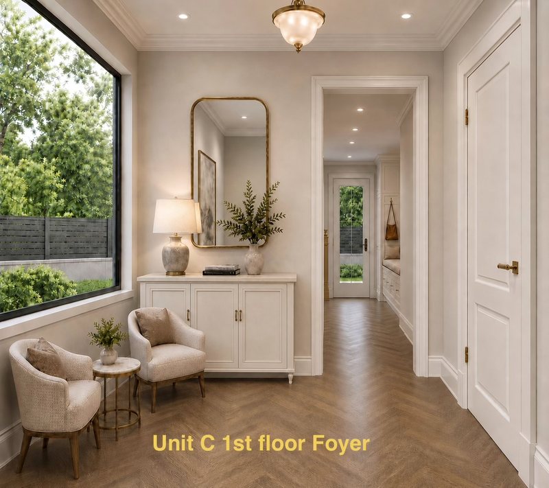 Unit C first-floor foyer with brass mirror and window seat hall