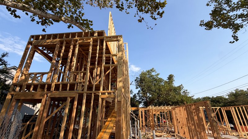 Low-angle view through the three-story frame at golden hour