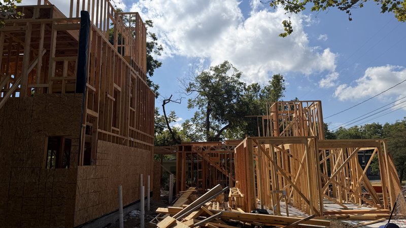 Homes 2 and 3 rising into their second stories