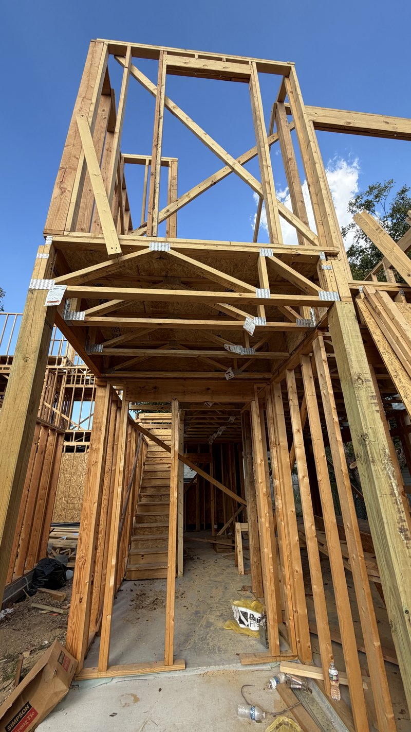 Looking up the stair tower through three framed levels