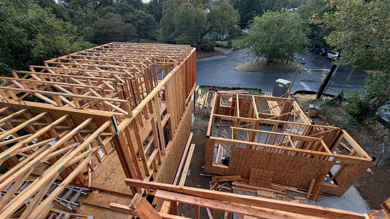 Looking down the row of homes from Home 1's roof, trusses across Homes 2 and 3